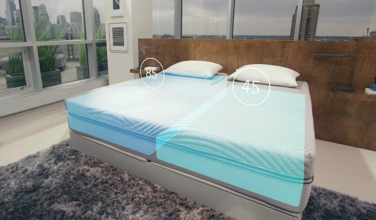 a bed with a blue sheet