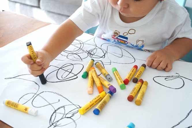 a child drawing on a paper