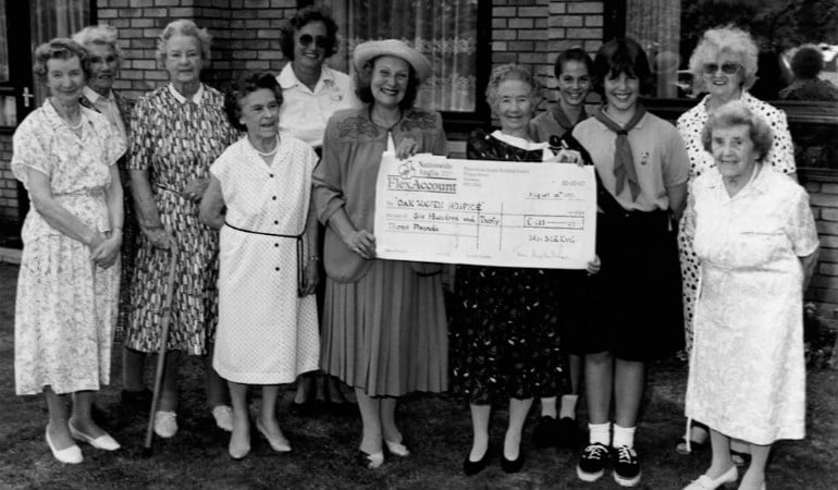 a group of women holding a sign