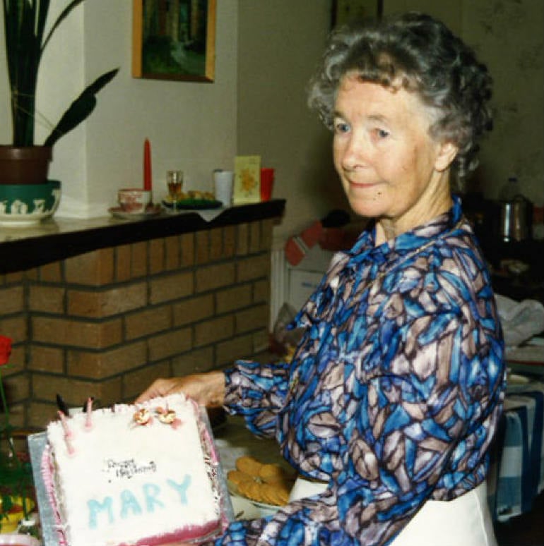 a person holding a cake