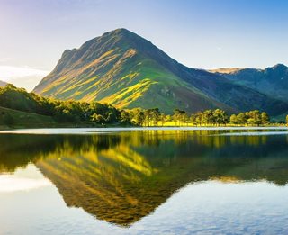 a body of water with a mountain in the background
