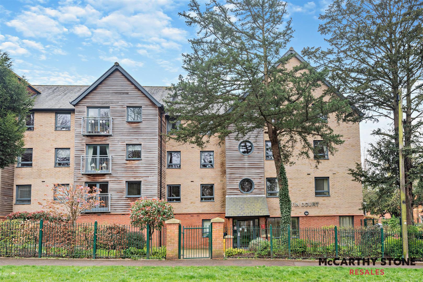a large brick building with trees in front of it