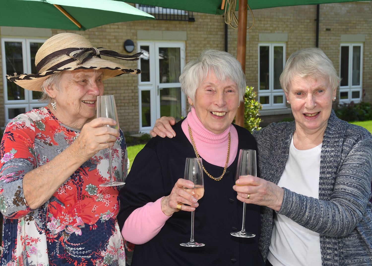 a group of women holding wine glasses