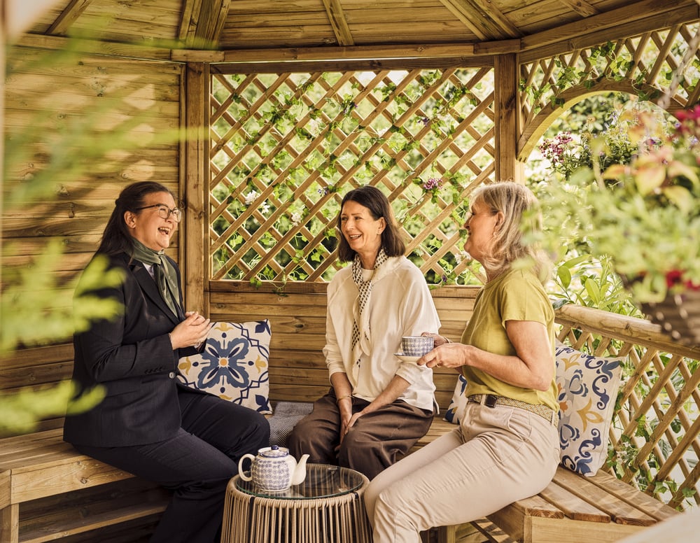 a group of women sitting on a bench