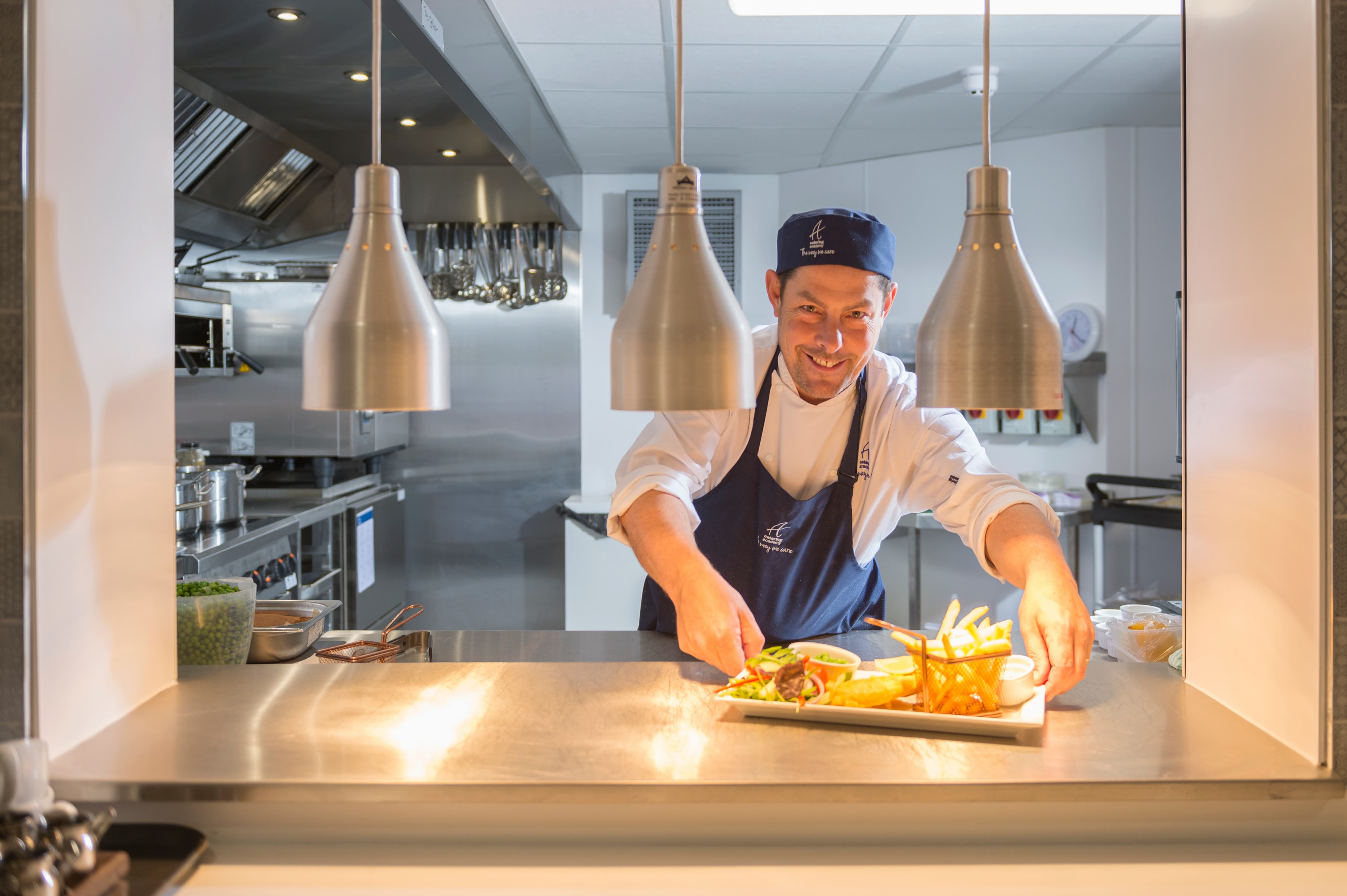 a chef preparing food in a kitchen