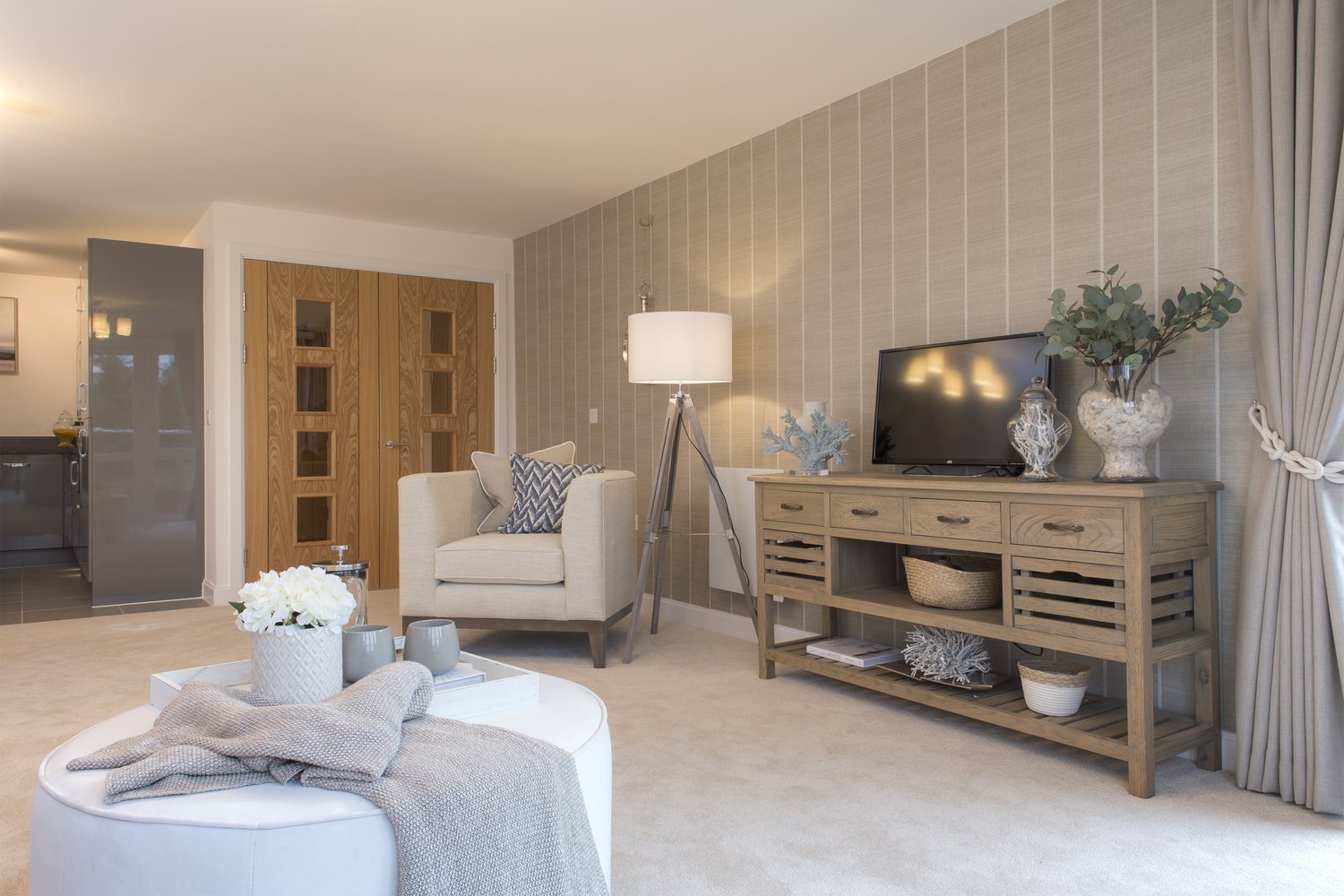 A stylish living room of a McCarthy Stone retirement property, complete with modern fittings and a contemporary colour scheme.