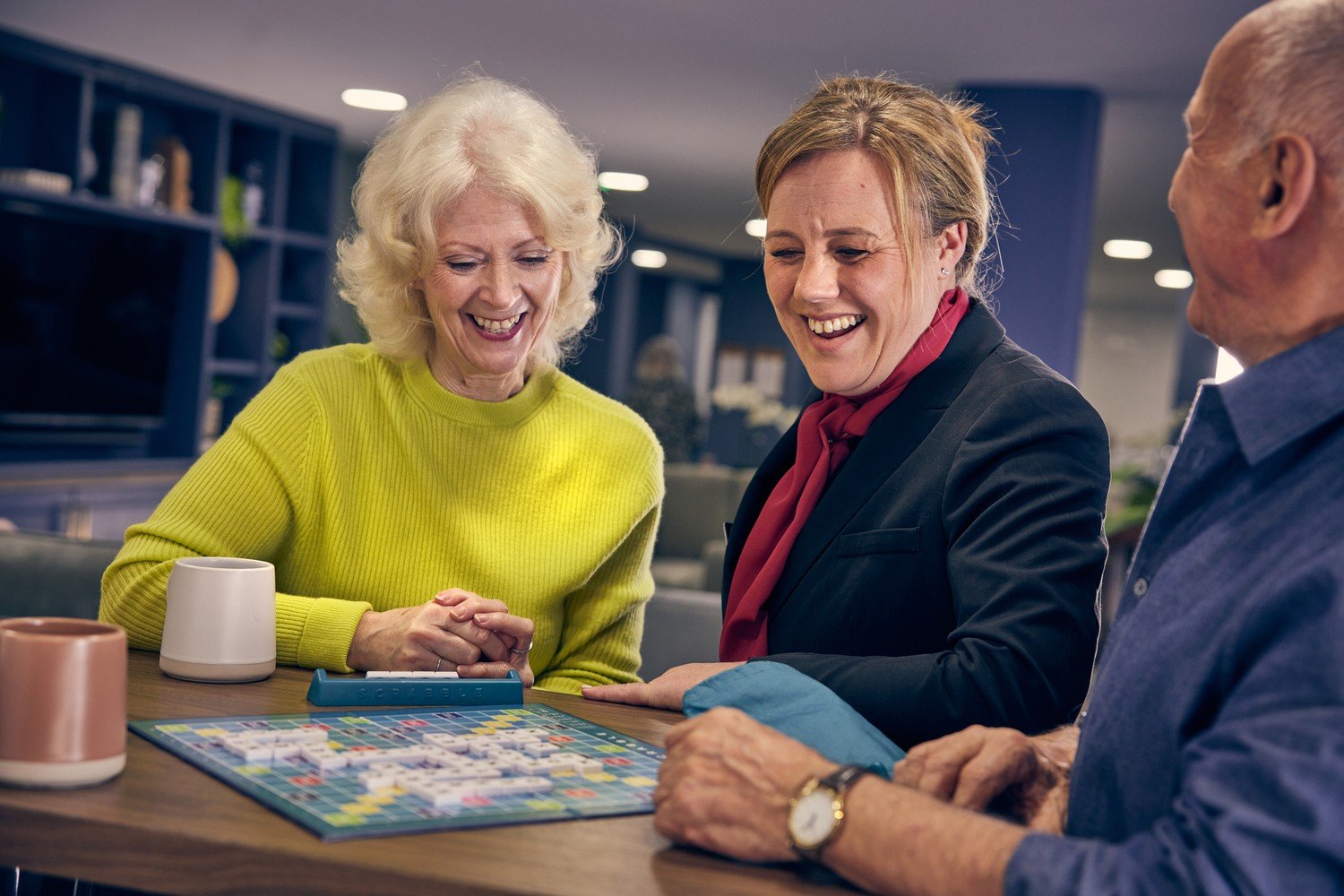 Seniors enjoying retirement living playing scrabble at their McCarthy Stone retirement home