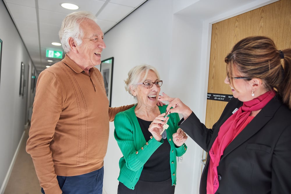 Couple being handed the keys to their new retirement property after they part exchanged their old home.