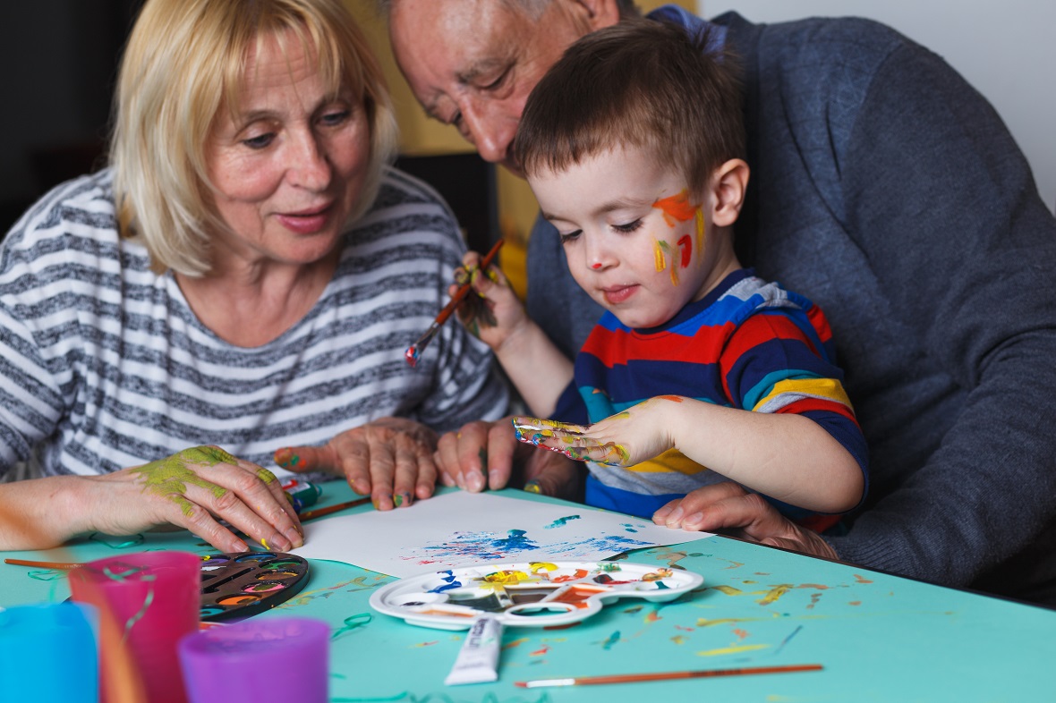 Grandparents painting with their grandson
