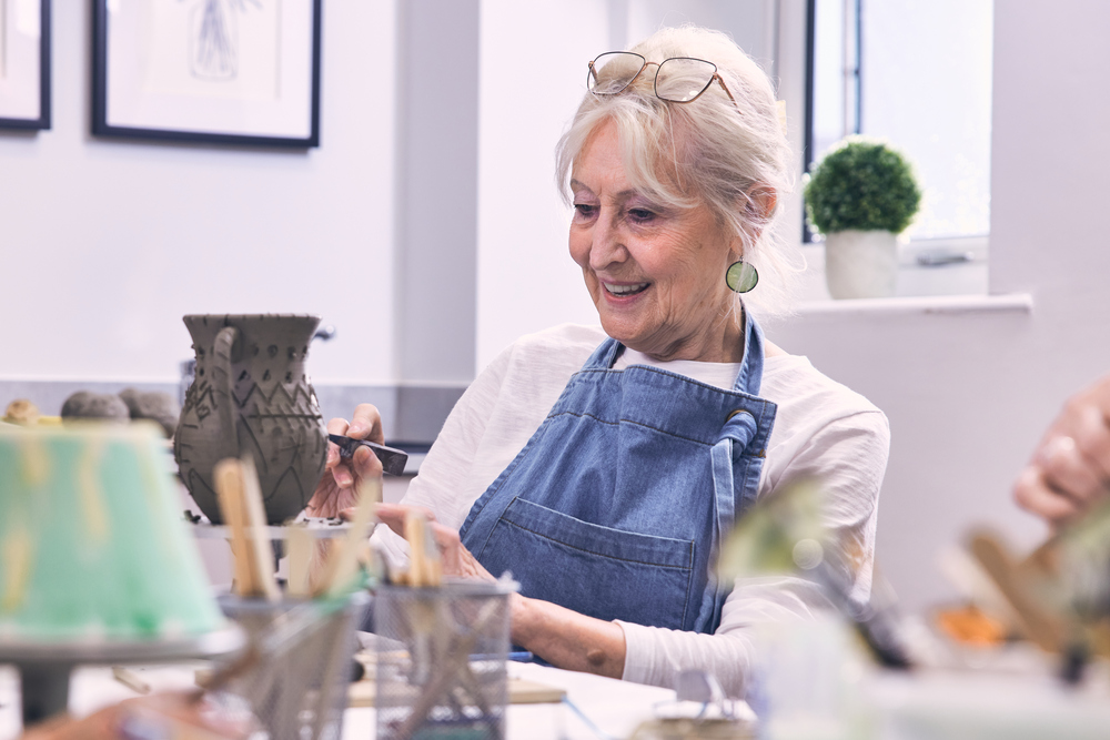 Woman makes a pottery vase in the craft room at her Retirement Living PLUS McCarthy Stone retirement home
