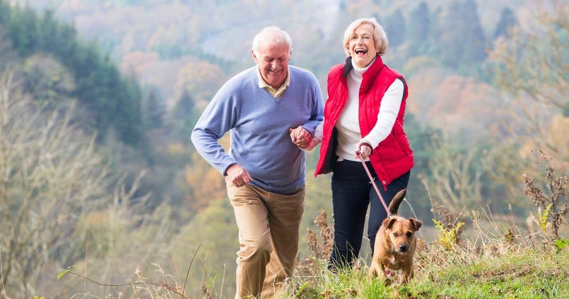 a man and woman walking a dog