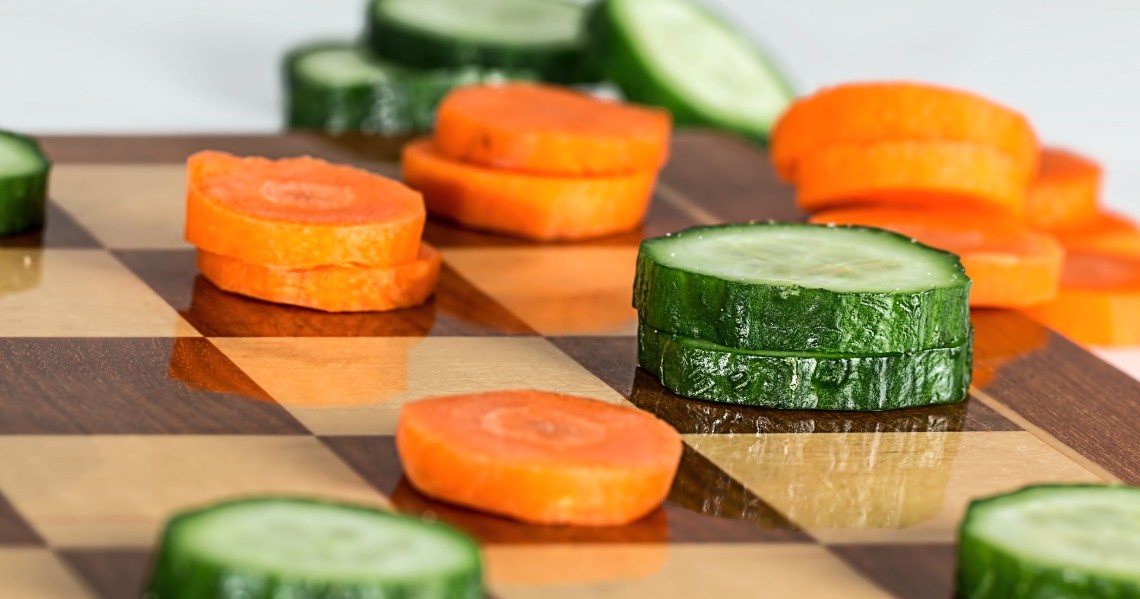 a cutting board with different colored sushi on it