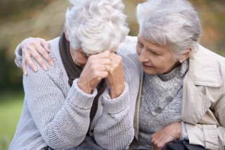 Grieving older woman coping after death of spouse