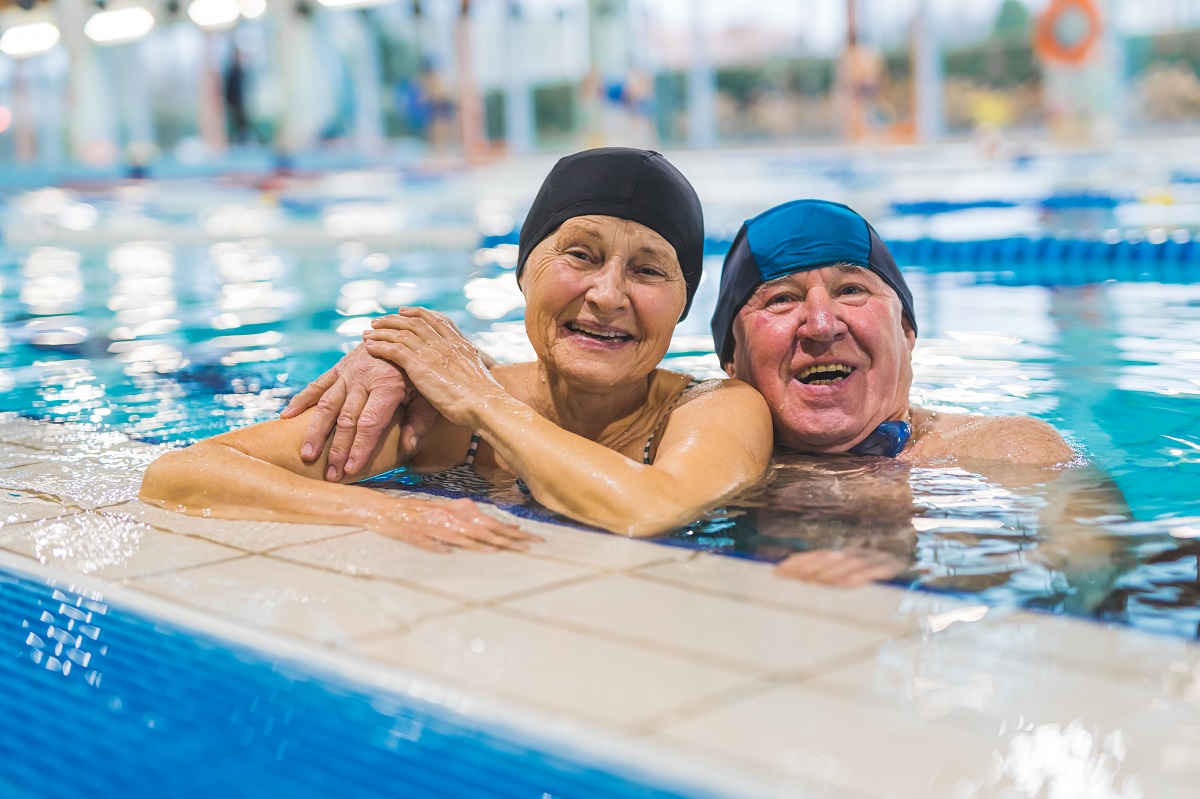 Older couple swimming to ease arthritis pain.