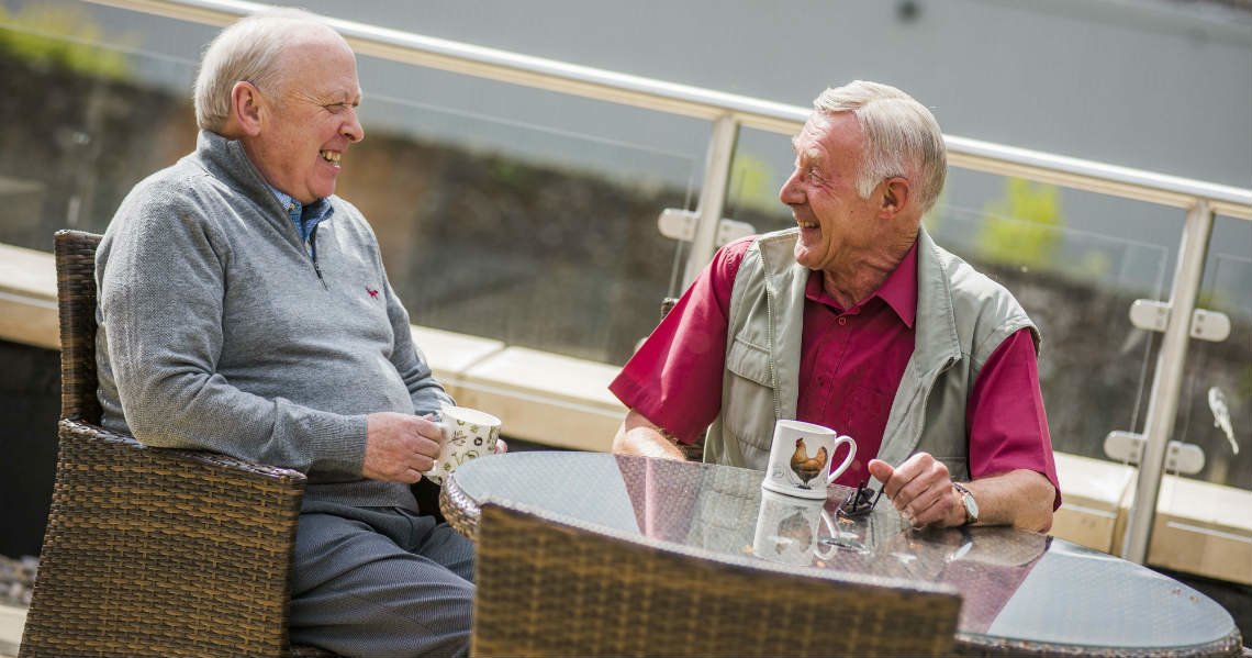 a couple of men sitting at a table