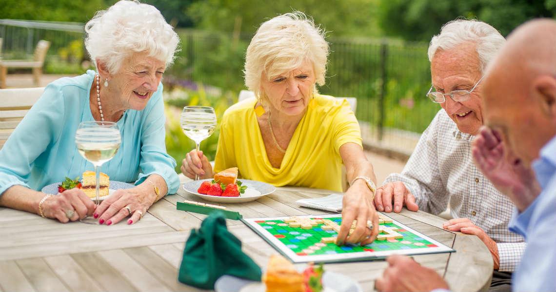 a group of people sitting around a table playing a board game