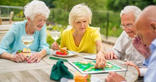 a group of people sitting around a table playing a board game