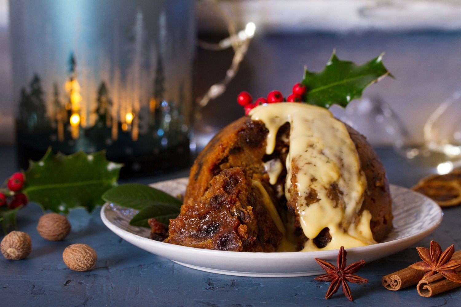 A christmas pudding on a plate with holly