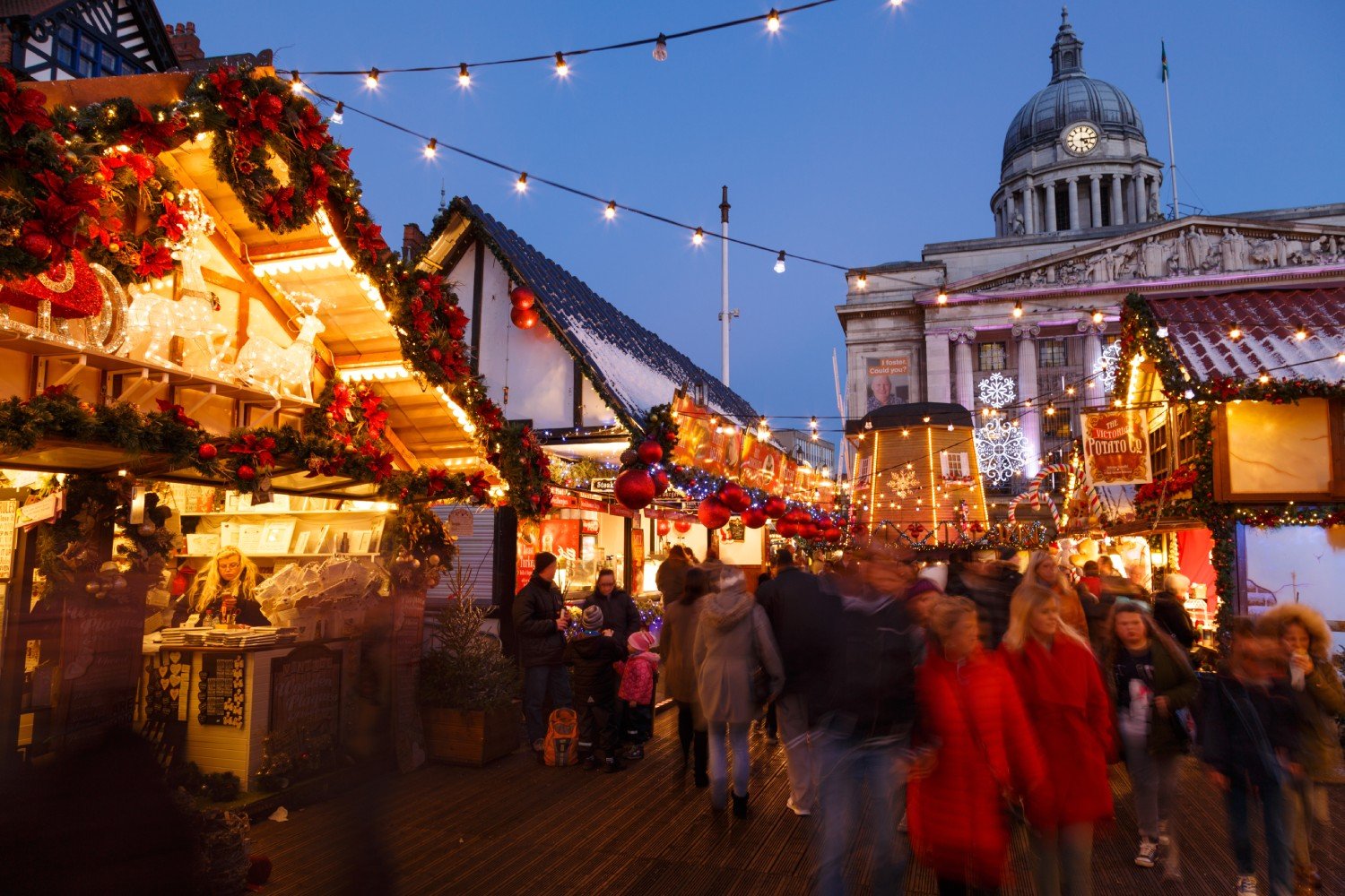 A crowd of people walking around Nottingham Christmas market