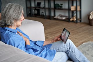 Seniors and technology: older person on a tablet chatting to family