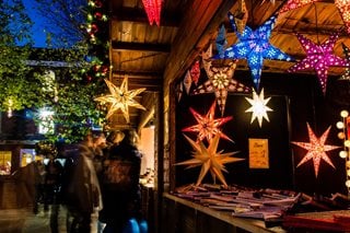 A UK Christmas market stand with lights