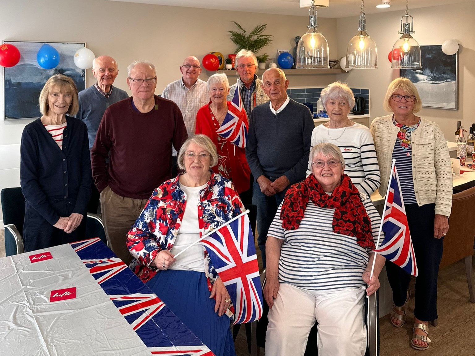 A group of retired people dressed up to commemorate VE day.