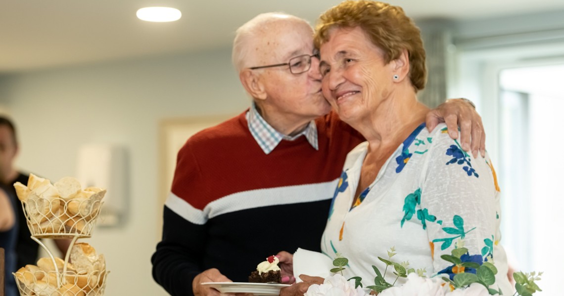 a man and a woman holding a plate of food