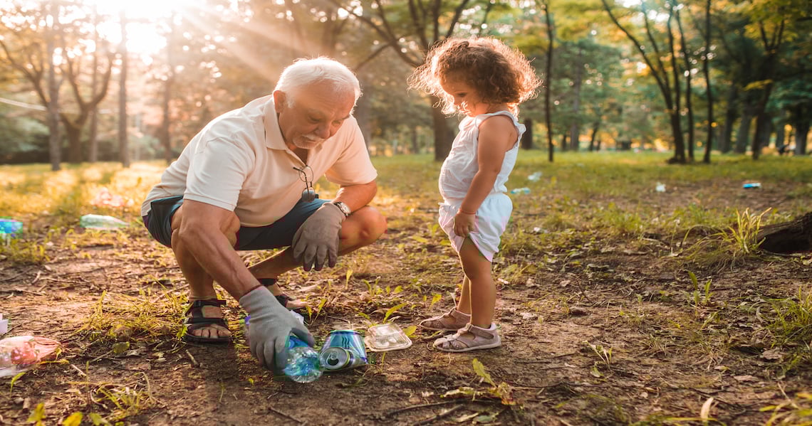 a man and a child playing with toys in a park