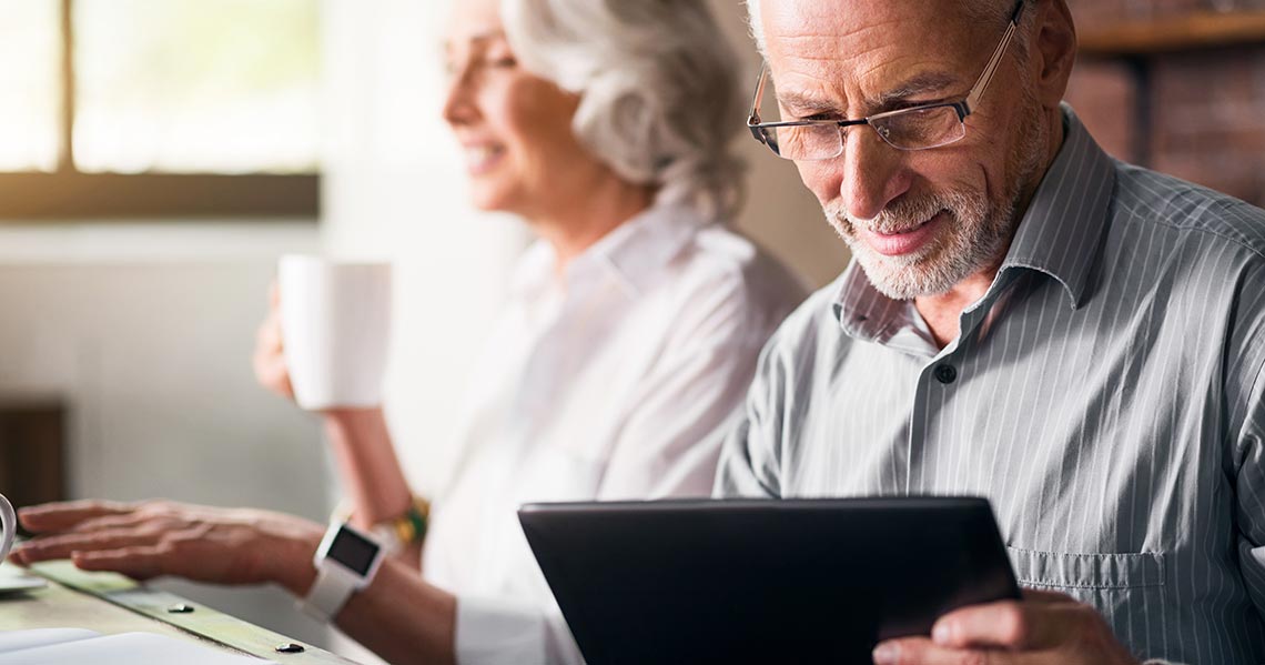 a man and a woman looking at a tablet