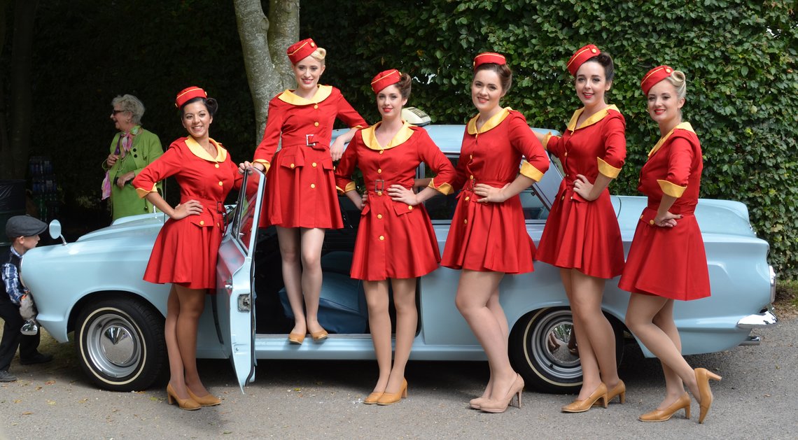a group of people in red dresses
