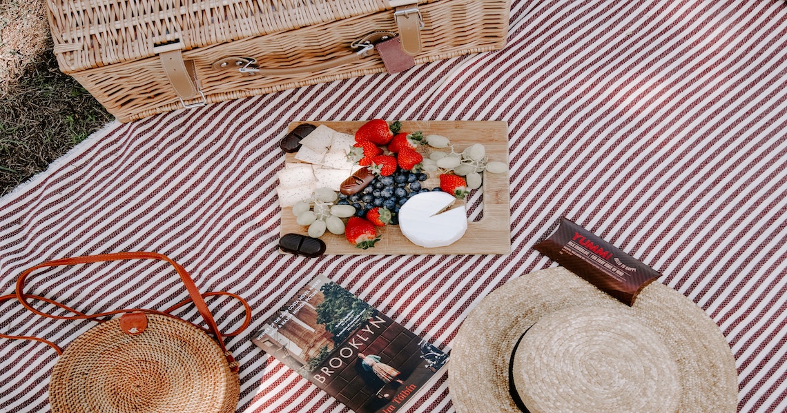 a picnic table with a basket and a basket of food