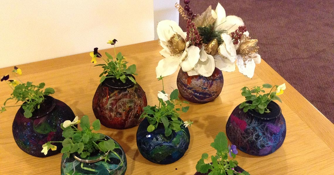 a group of vases with flowers