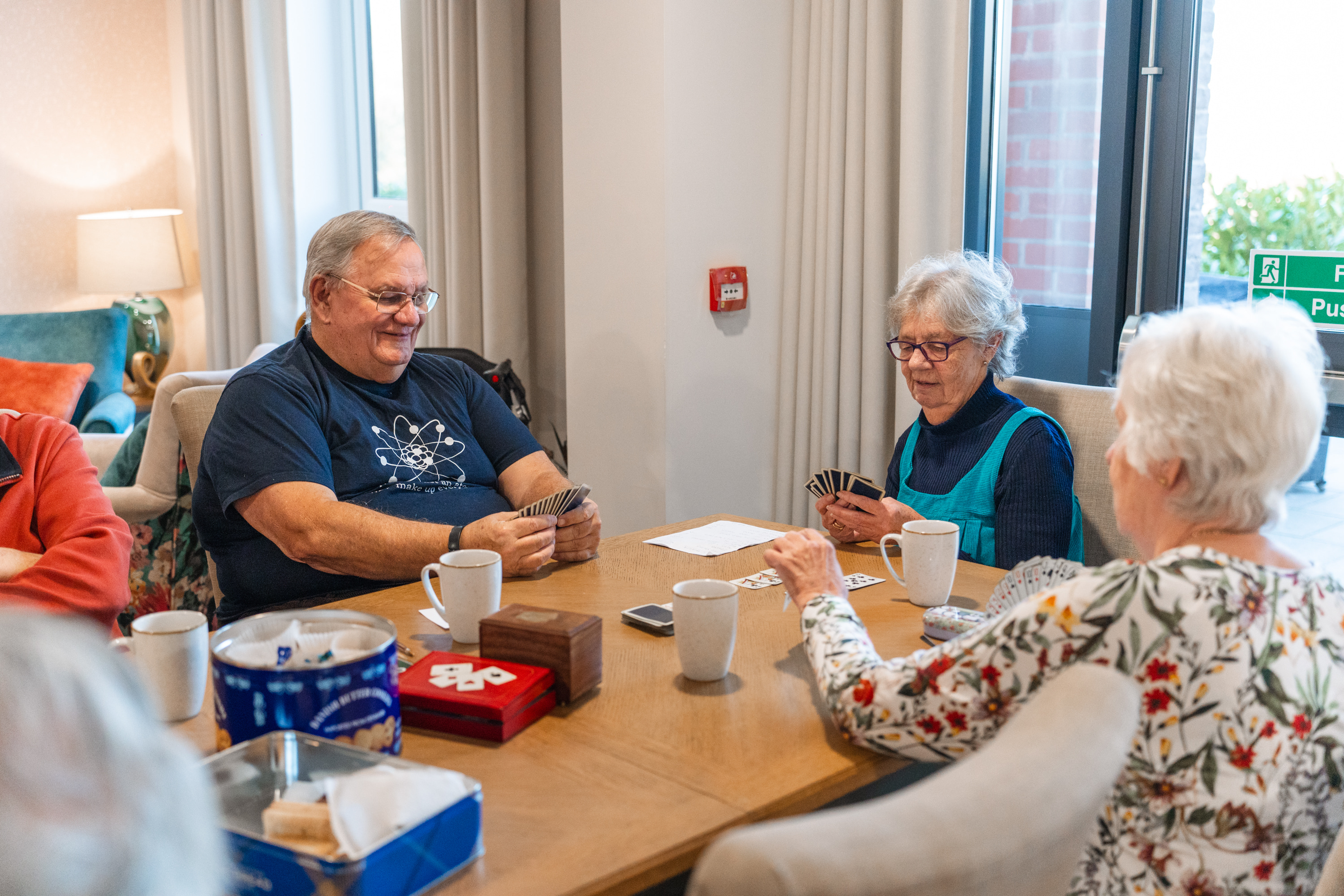 Simon and his friends enjoy card games at Stour Gate a retirement living community in Blandford Forum in Dorset.