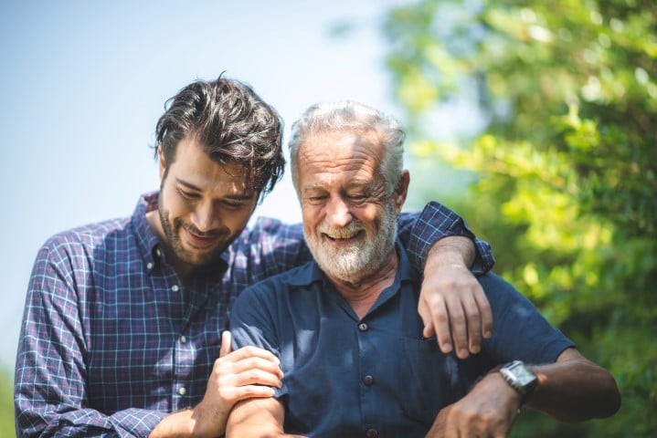 The history of fathers day illustrated with a father and son hugging