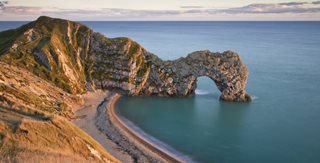 a large rock formation over a body of water