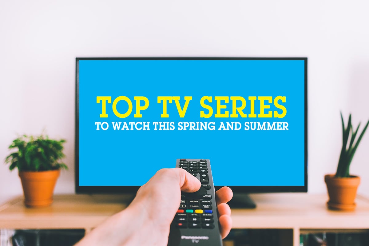 a hand holding a remote control