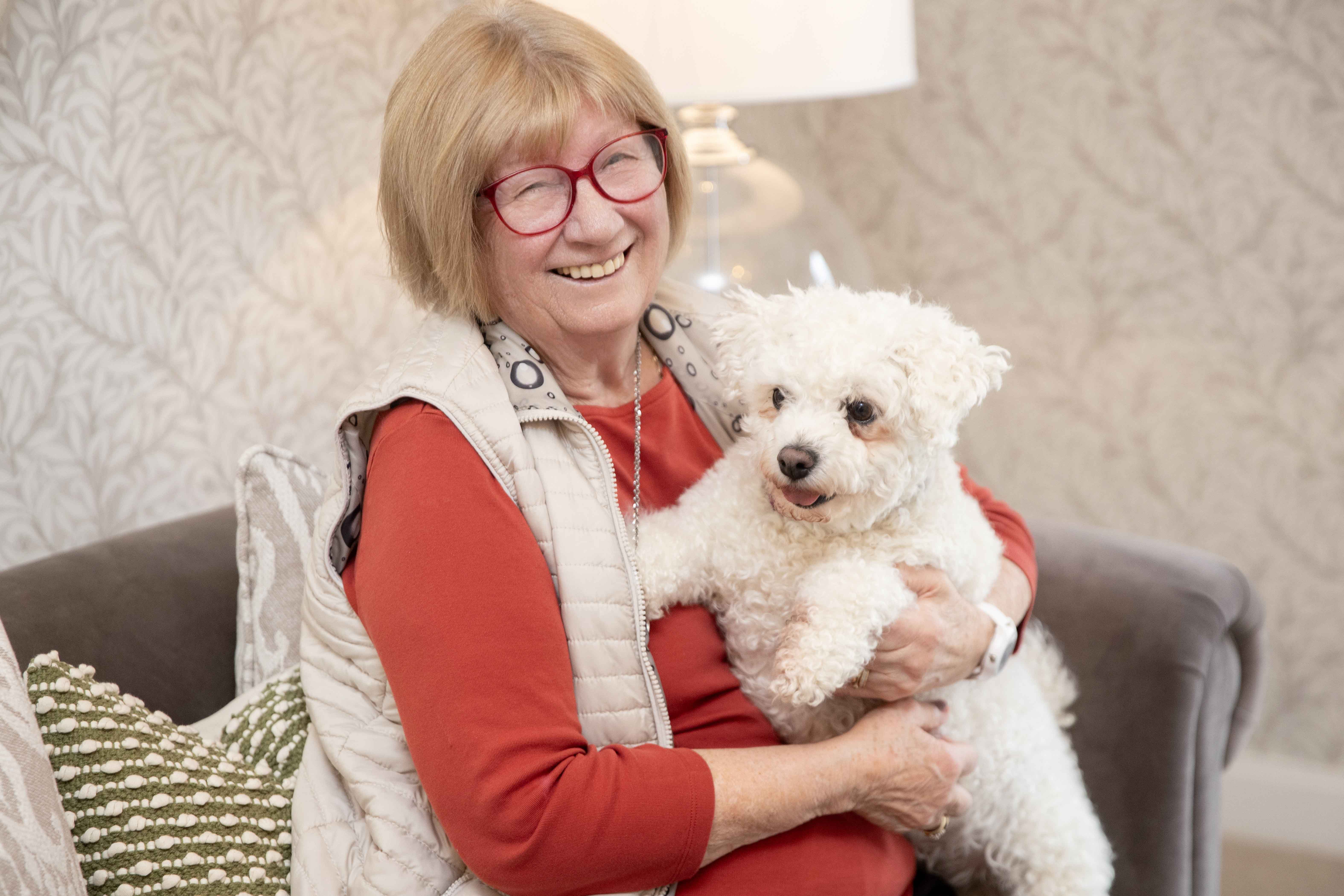 a woman holding a dog