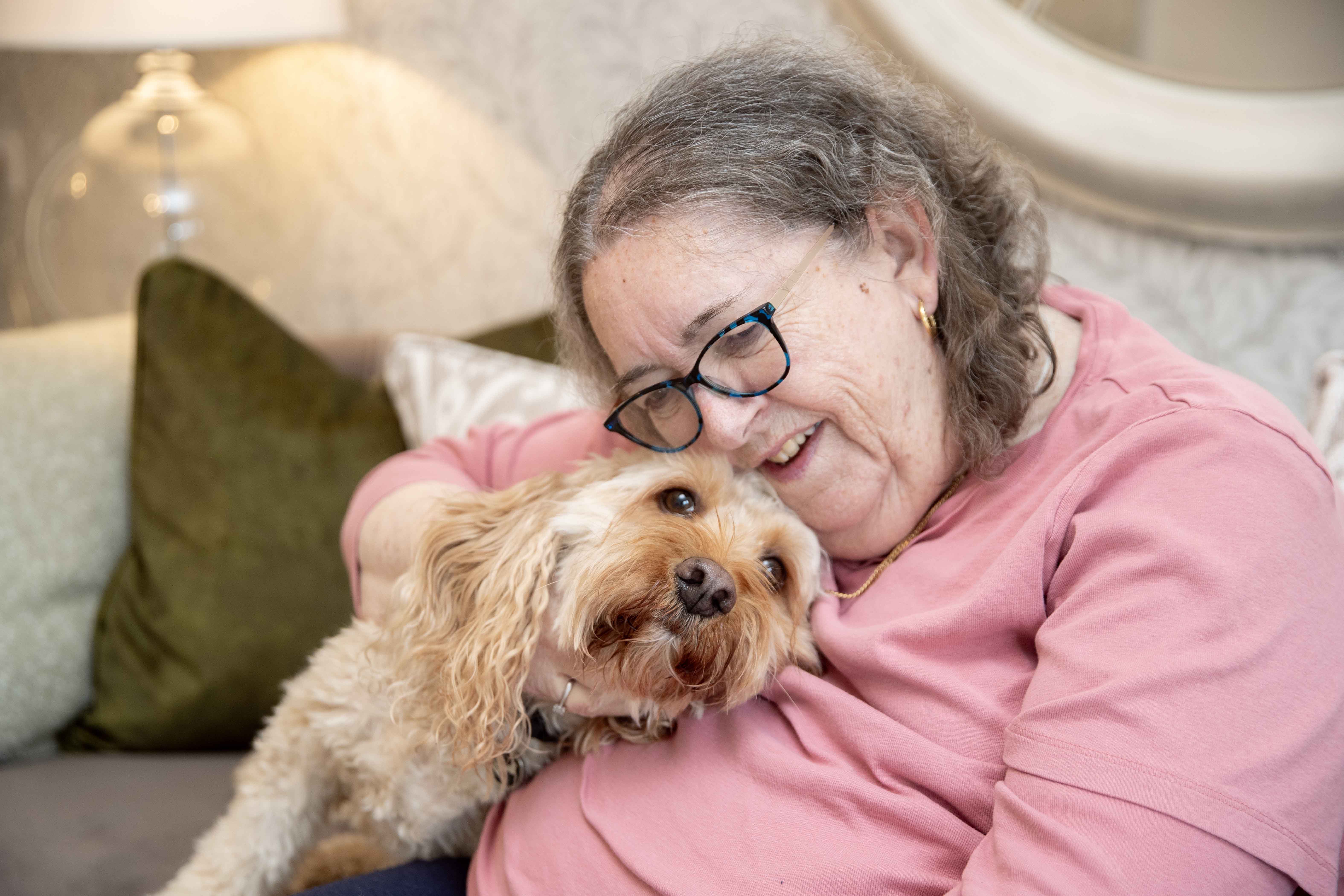 a person lying on a couch with a dog