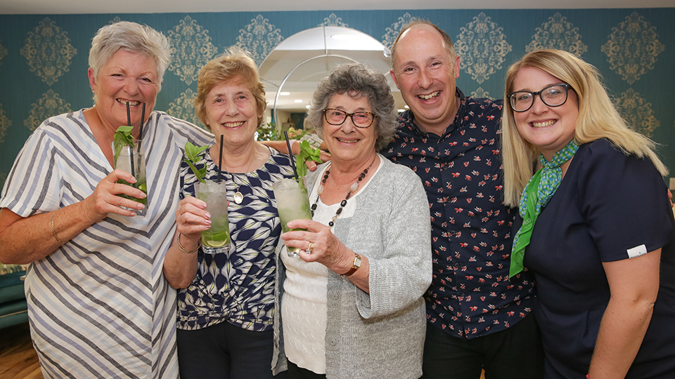 a group of people holding drinks