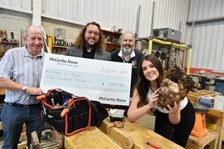Staff from McCarthy & Stone present the Men in Sheds Group in Blidworth with a donation.