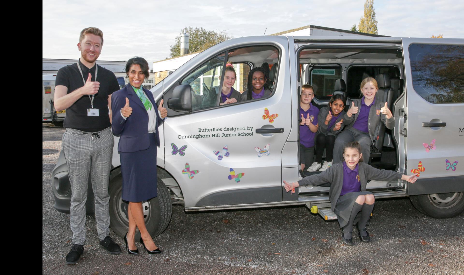 a group of people standing next to a van