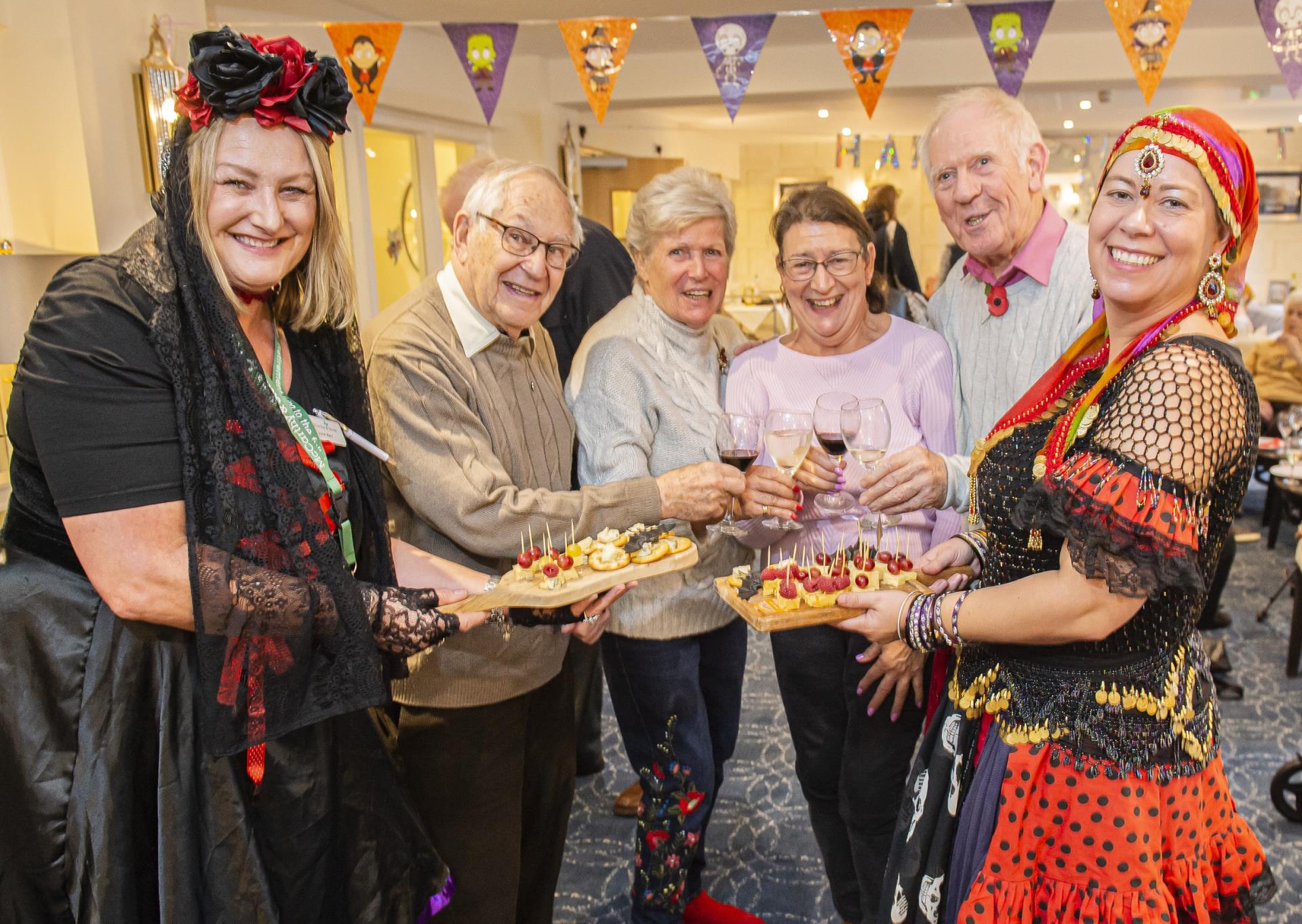 a group of people holding a plate of food
