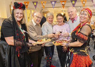a group of people holding a plate of food