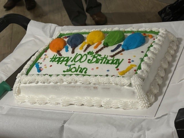John’s 100th birthday cake in the shared lounge of his Retirement Living PLUS development