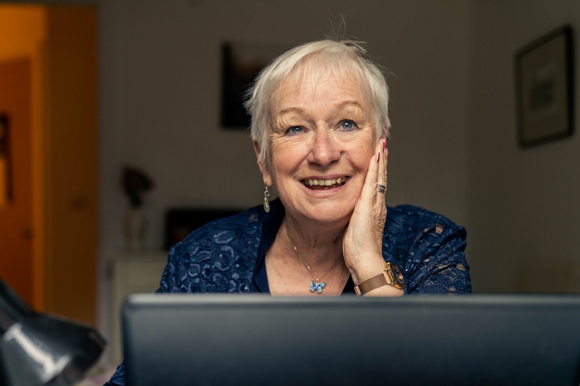 Helen smiling over her PC screen