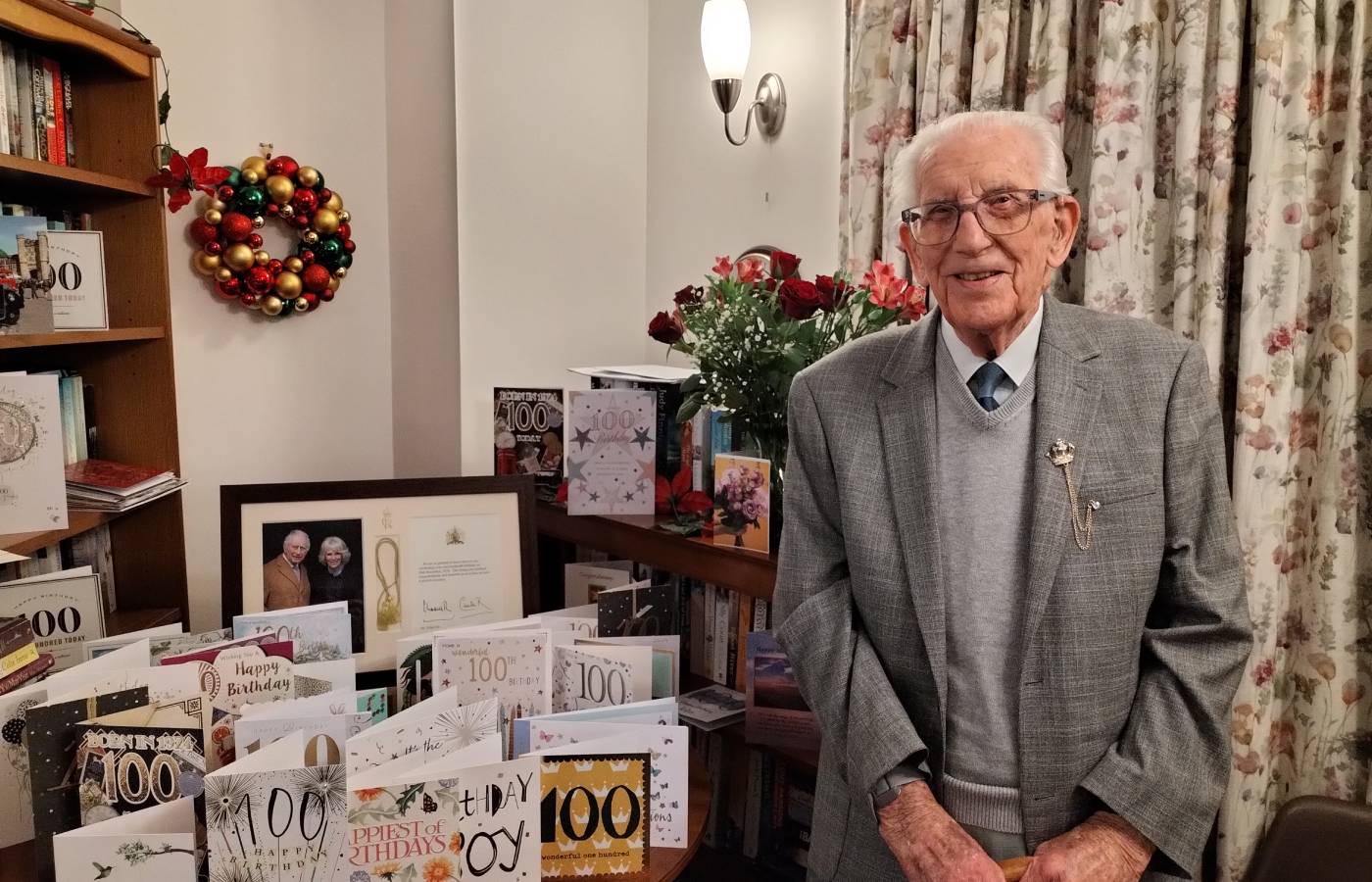John celebrates 100 birthday in his McCarthy Stone retirement living property Clevedon. He is shown with his 100 birthday cards