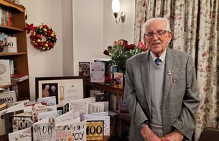 John celebrates 100 birthday in his McCarthy Stone retirement living property Clevedon. He is shown with his 100 birthday cards