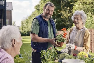 Gardener Adrian chats to homeowners in the shared gardens at our retirement homes in Olney, Buckinghamshire.