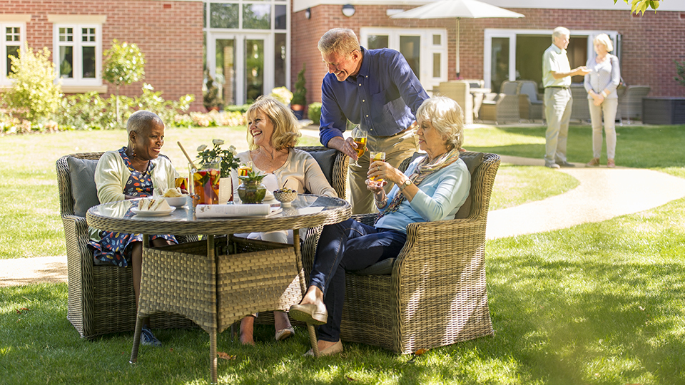 a group of people sitting around a table outside