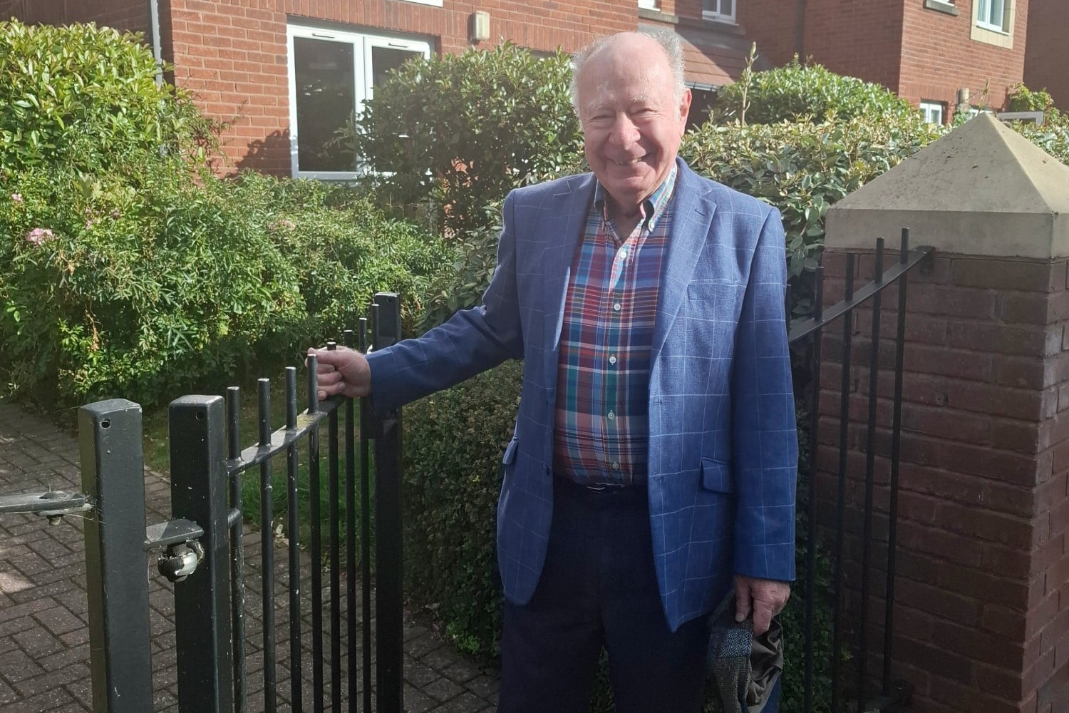 Professor James Hirshfield stands outside his McCarthy & Stone retirement community in Birmingham
